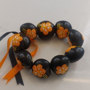 Hawaiian Black Beaded Bracelet with Orange Floral Design